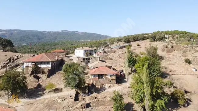 A 1000 square meter land in Manisa Demirci within the village with electricity, road, and water ready for construction