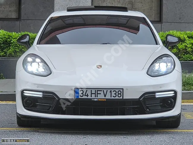 Porsche Panamera 4 with an updated front fascia, new type of headlights, and bumper from Bi Motors