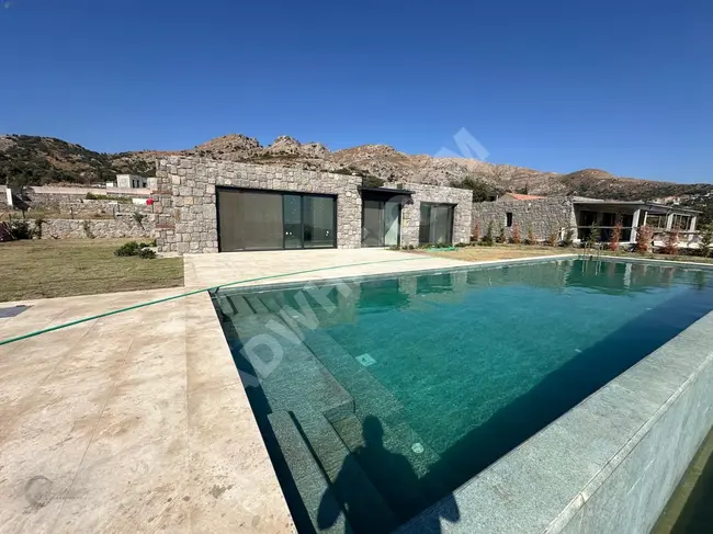 Villa in Gumusluk with an area of 80 square meters, featuring a pool and a wide garden area - from Camur