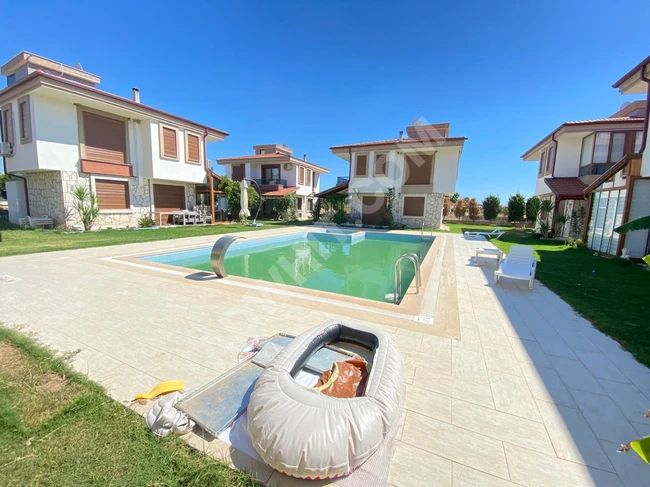 3+1 villa for sale in Dogan Bey within a residential complex with a very luxurious pool