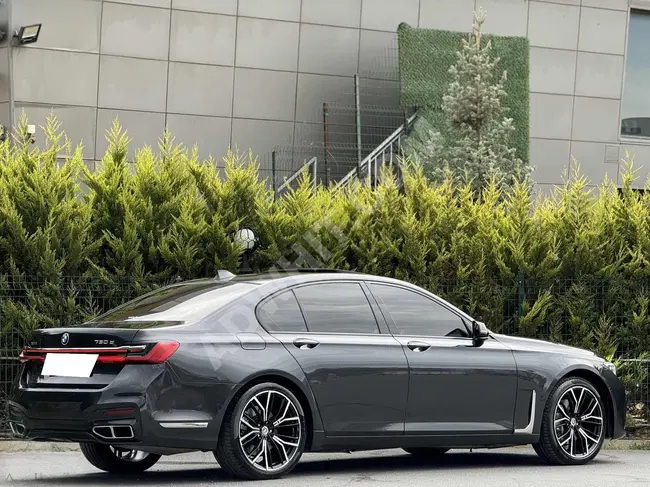 BMW 730d xDrive car with suction system and seat heating, brown interior color (TABA), and face lift modification from KARLIK AUTO.