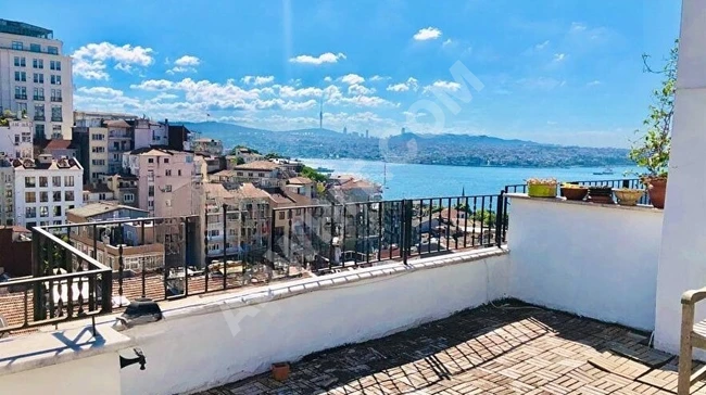 A duplex apartment (2+1) with an area of 140 m² in Cihangir, featuring a fantastic sea view, great balcony, air conditioning (2 units), and central heating.