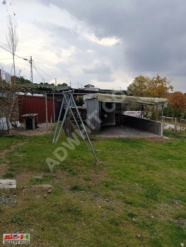 A plot of land with a house for sale in Göçbeyli