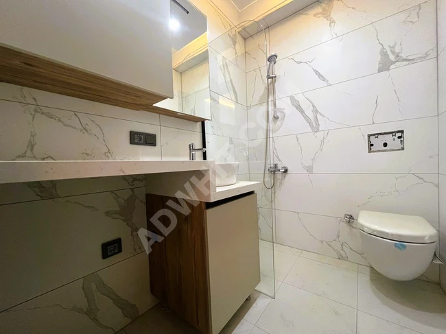 2+1 Apartment with a front facade on a mid-level floor, featuring a master bathroom from ALÇINAR EMLAK