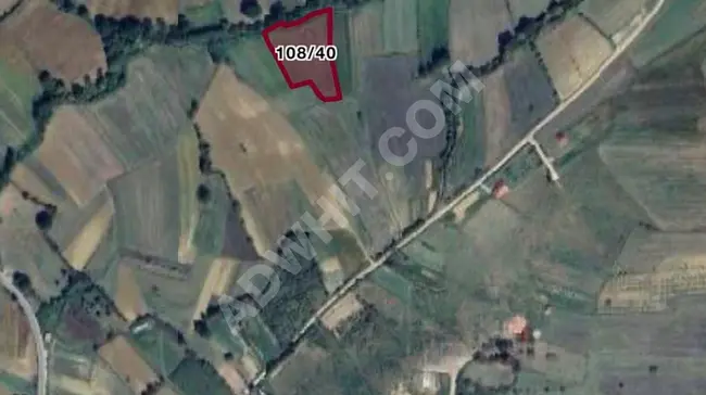 Land for sale with an area of 4678 m2 near the village, 5 minutes from the sea in the KANDIRA ÖZBEY area.