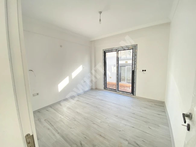 Detached villa 3+1 with underfloor heating for sale with a living room and separate kitchen in Doğanbey.