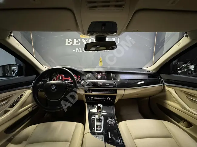 BMW 520i PREMIUM car, model 2014, with memory seats, digital gauges, and a vacuum door suction system.