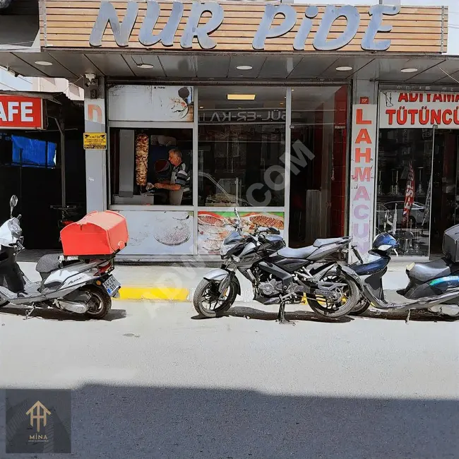 A commercial outlet for sale, yielding its rights, selling bread, meat pies, and shawarma on a main street.