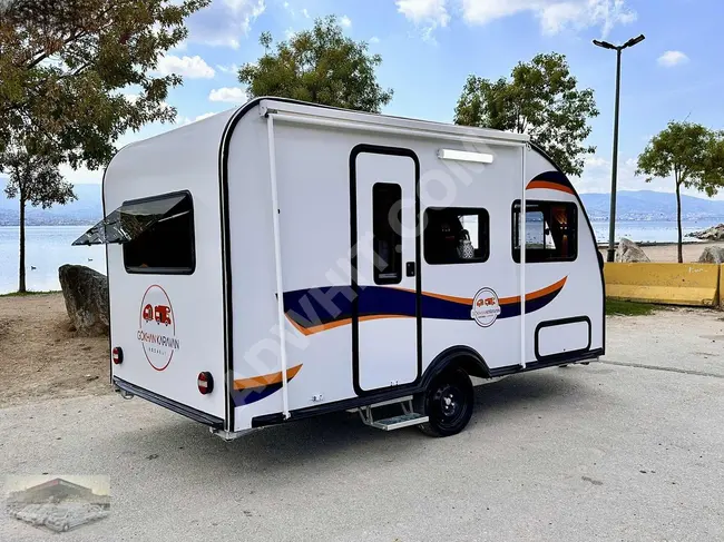 2024 Caravan from GÖKHAN KARAVAN equipped with a foldable bunk bed, solar panel, tent, Webasto heating system, TV, and toilet.