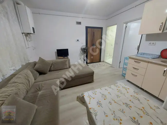 A fully furnished 1+1 apartment with a garden in a new building in the Doğancılar area.