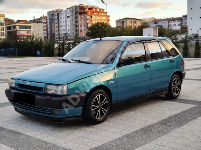 FIAT TIPO 1.4 S Car Model 1998 with an original distance of 246,000 km, clean, with a power of 70 horsepower, green color.