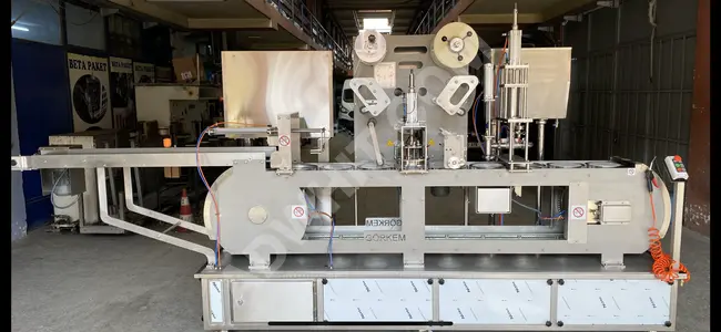 Automatic foil (aluminum foil) cutting and pasting machine.