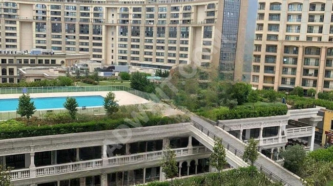 1+1 apartment for sale with a view of the complex gardens, including additional accessory costs.