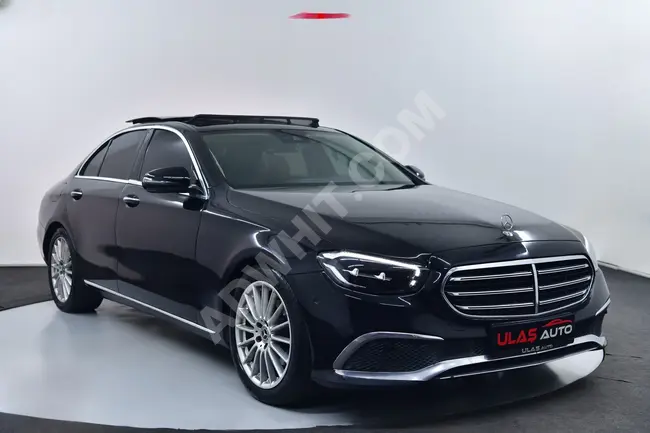 سيارة Mercedes - Benz E 200 d موديل 2022 فرامل متطورة/ مقاعد بذاكرة/إغلاق كهربائي للصندوق/مسافة 26,000 كم/من الوكيل