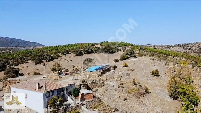 1000m2 plot of land with electricity, water, and road, ready for building. Located within the village in MANİSA DEMİRCİ.