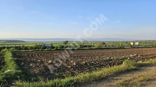 Land for sale with an area of 2,200 square meters in a prime location between two highways and a sea view