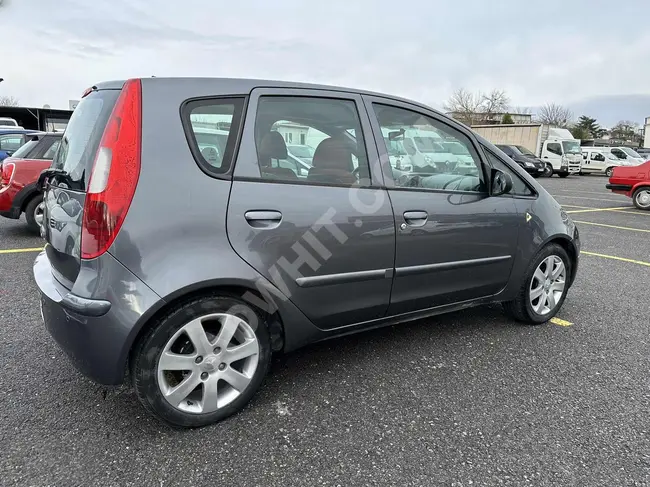 Mitsubishi Colt car maintained by the agency, featuring a panoramic roof and an automatic system.