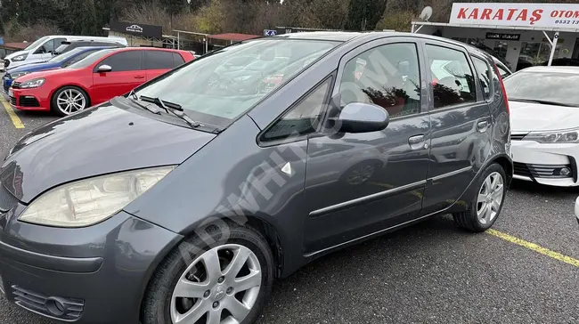 Mitsubishi Colt car maintained by the agency, featuring a panoramic roof and an automatic system.