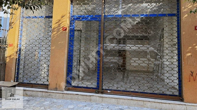 A shop on the corner with a straight entrance near the tramway.