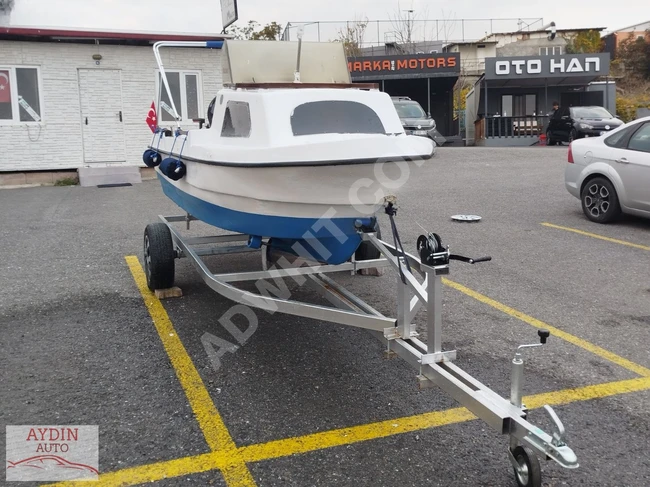 MURSAN 2003 boat with a 25-horsepower engine, cabin, steering, and trailer.