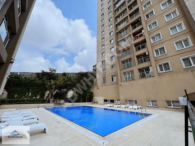 1+1 apartment in the YILDIZ PARK complex with a pool and parking lot.