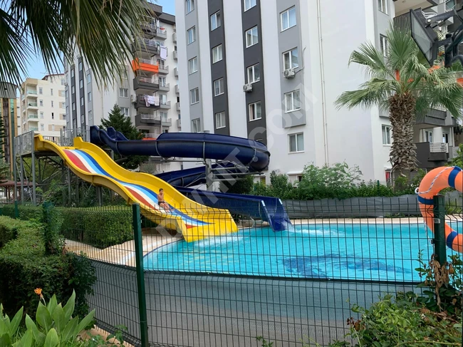 Apartment for sale 3+1 in Antalya Konyaalti with a complex featuring two swimming pools and water games.