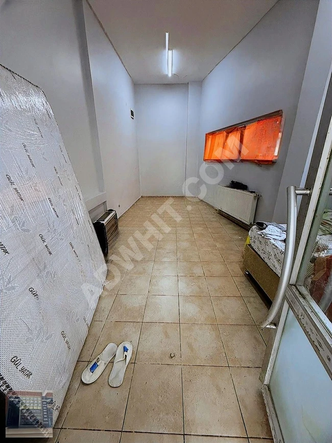 A shop with open facades located on GÜZELDERE Street, containing a bathroom and a kitchen.