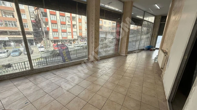 A shop with open facades located on GÜZELDERE Street, containing a bathroom and a kitchen.