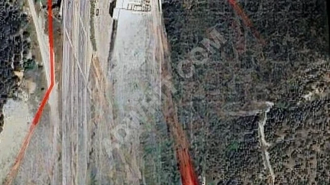 Level land for sale in BİLECİK MERKEZ with a river running next to it.