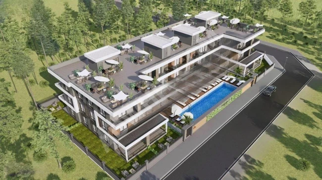 2+1 apartment for sale in a residential location with a swimming pool, underfloor heating, 500 meters from the sea, with a prime location.