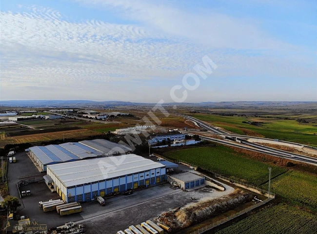 A wonderful plot of land overlooking an asphalt road.