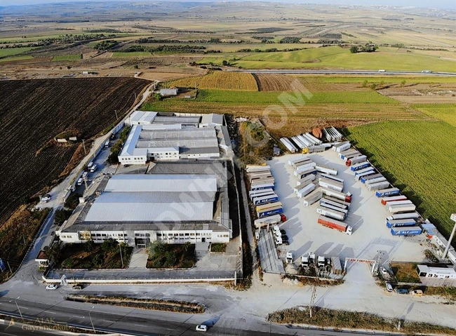 A wonderful plot of land overlooking an asphalt road.