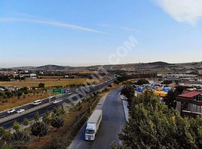 A wonderful plot of land overlooking an asphalt road.