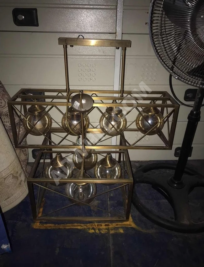 A collection of luxurious decorative chandeliers offered for sale, complete with their lamps.