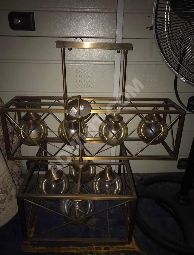 A collection of luxurious decorative chandeliers offered for sale, complete with their lamps.