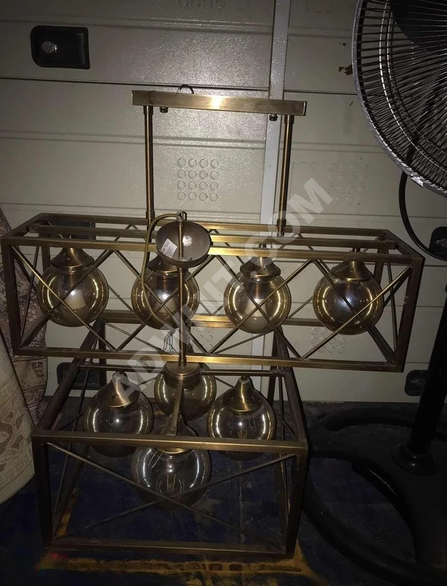 A collection of luxurious decorative chandeliers offered for sale, complete with their lamps.